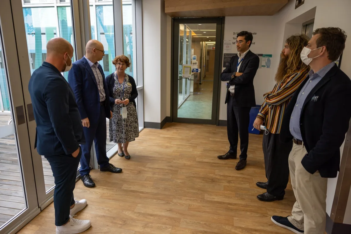 Clinicians and healthcare leaders touring a modern mental health facility together