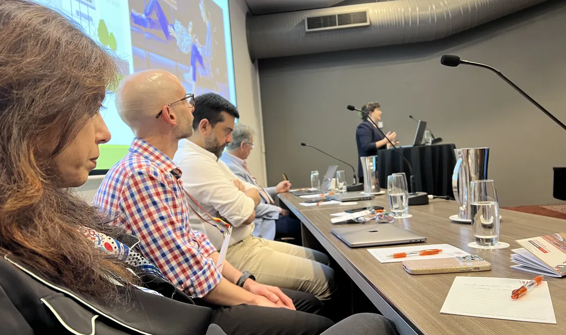 Clinicians seated at a boardroom table during a MindSkiller education session